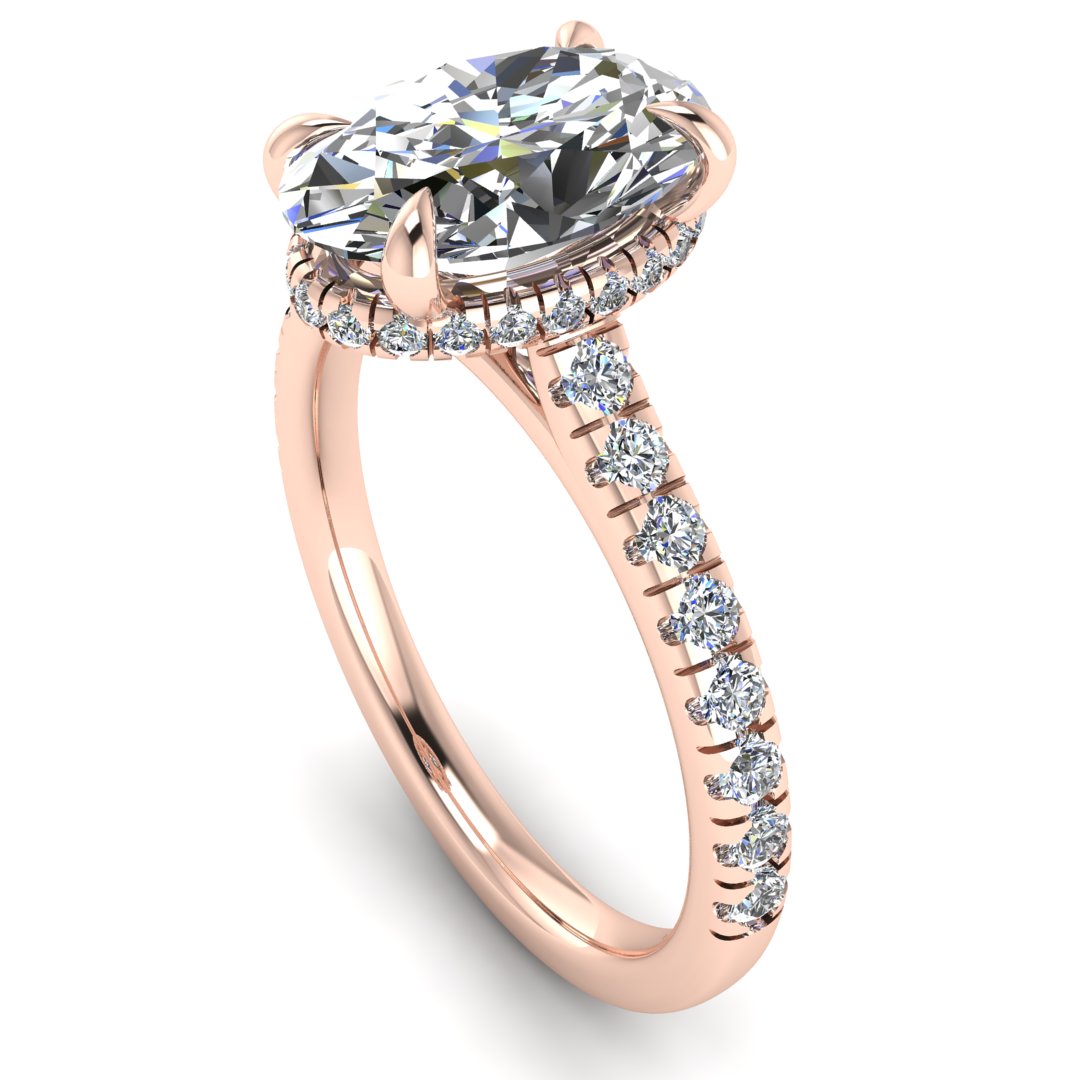 Angled view of rose gold oval cut lab grown diamond engagement ring with secret hidden halo and diamond band