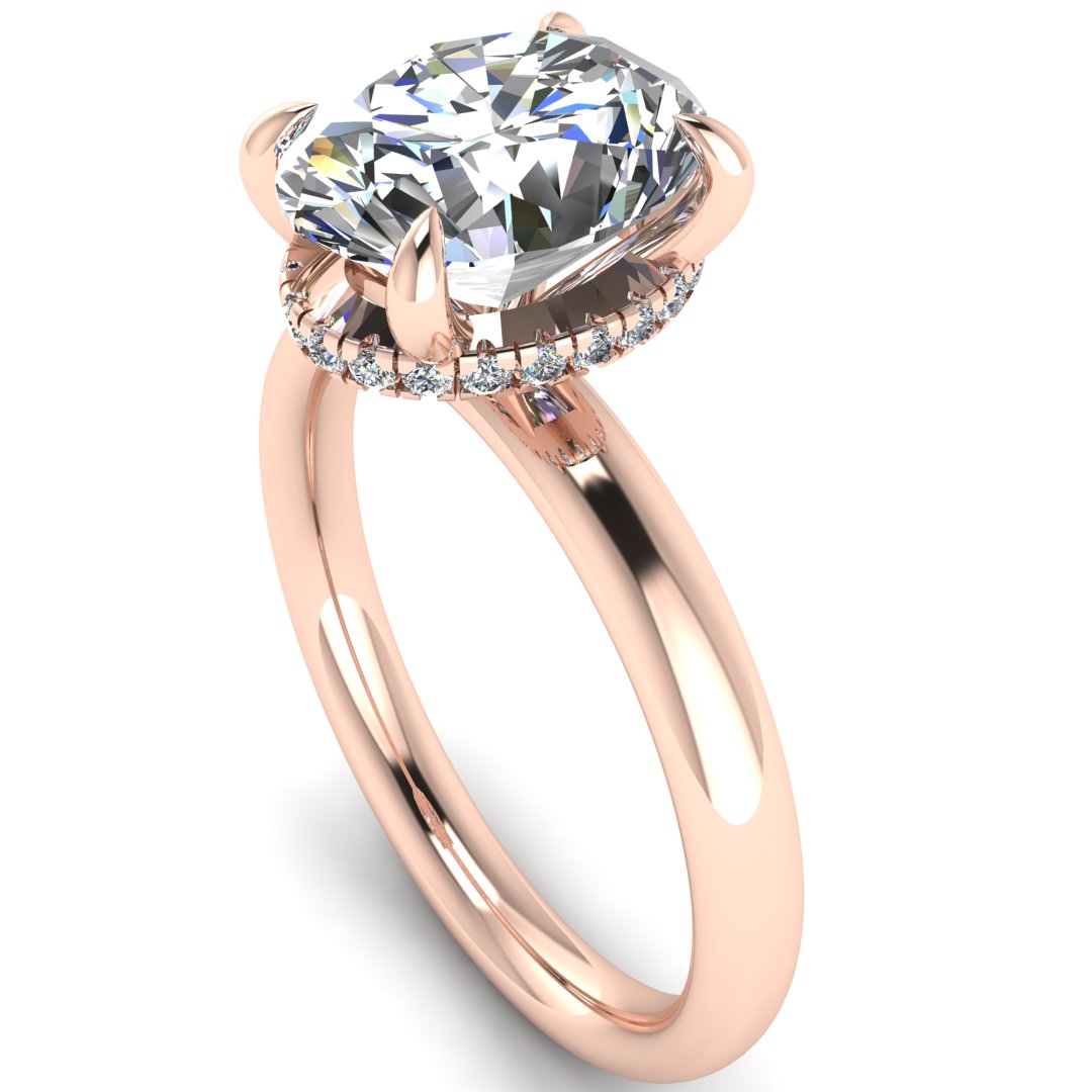 angled view of a rose gold engagement ring with a oval cut lab grown diamond with a secret hidden halo