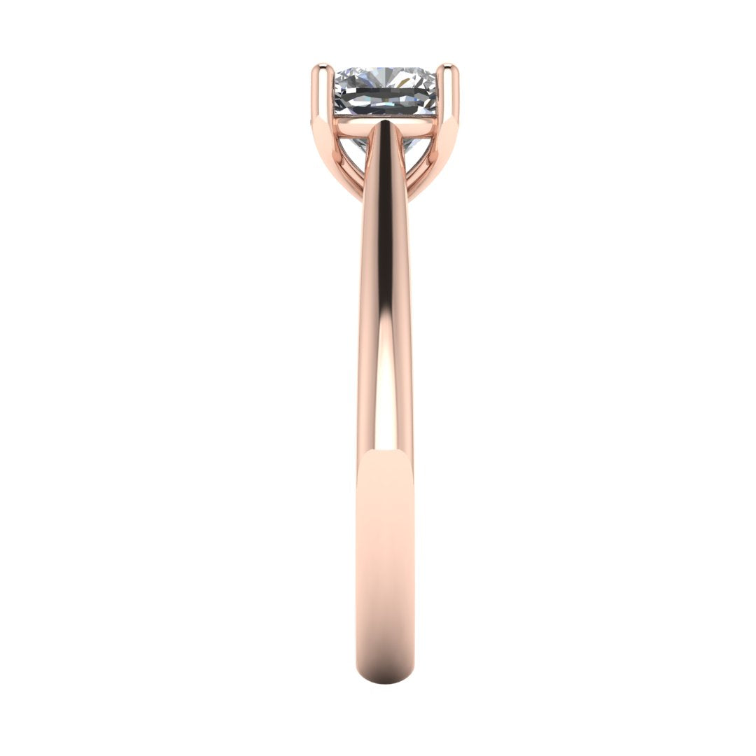 side view of a rose gold single solitaire engagement ring featuring a cushion cut lab grown diamond in a cathedral setting with 4 claws