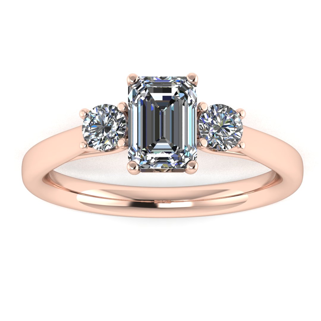 front view of a trilogy rose gold engagement ring set with an emerald centre lab grown diamond with two round brilliant diamonds on either side of the centre stone