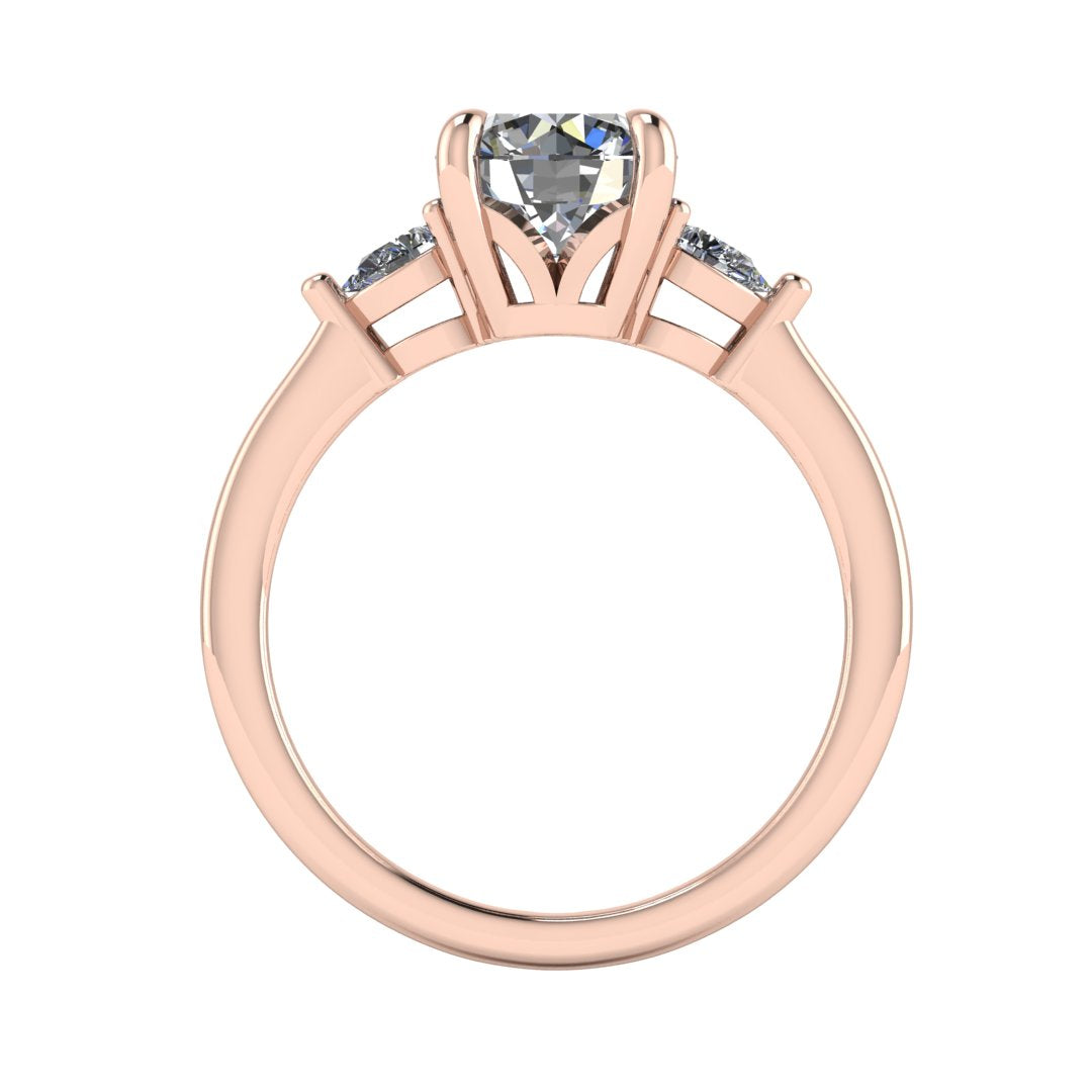 Flat view of a rose gold trilogy engagement ring using round and pear shaped lab grown diamonds