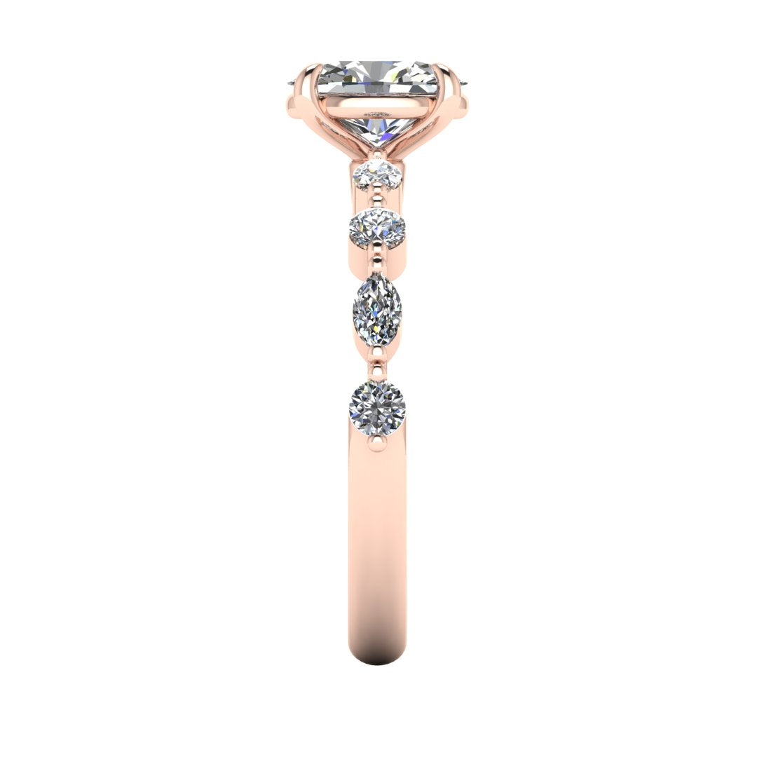 side view of rose gold of Lily engagement ring with an oval cut centre stone surrounded by alternating smaller round and marquise stones on the shoulder
