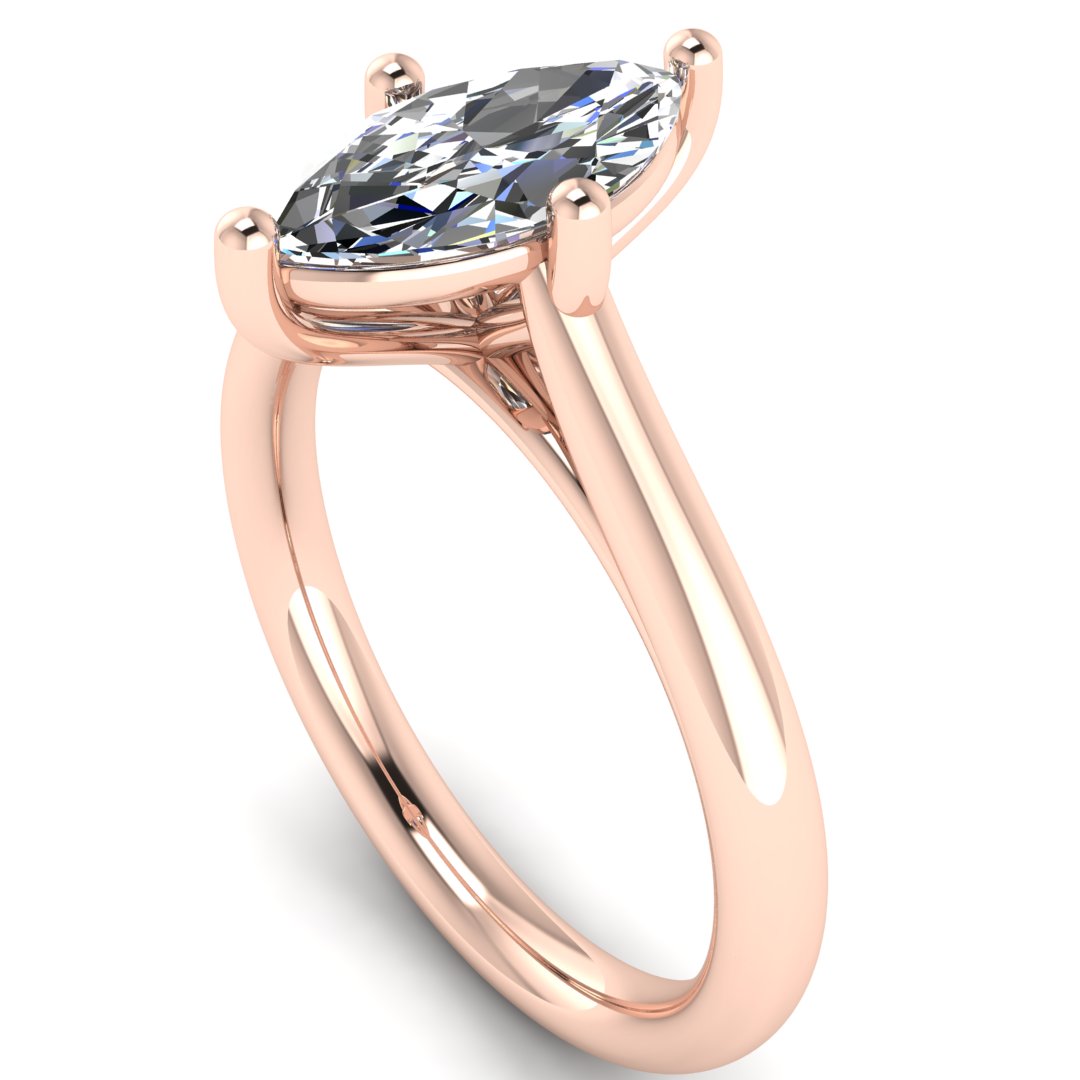 angled view of rose gold single solitaire engagement ring with a marquise cut lab grown ethical and sustainable diamond in a cathedral setting