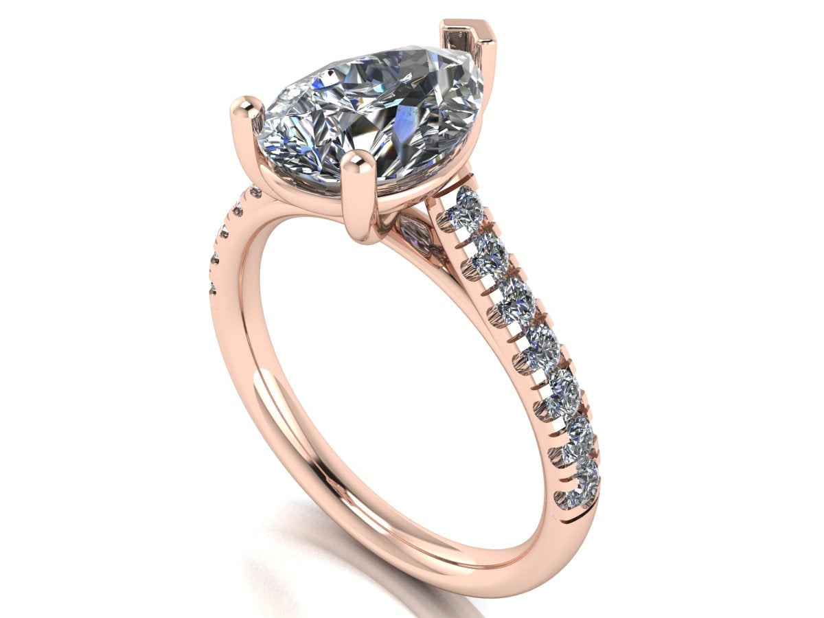 angled view of rose gold pavé engagement ring with a pear shaped centre lab grown diamond and microset diamond shoulder