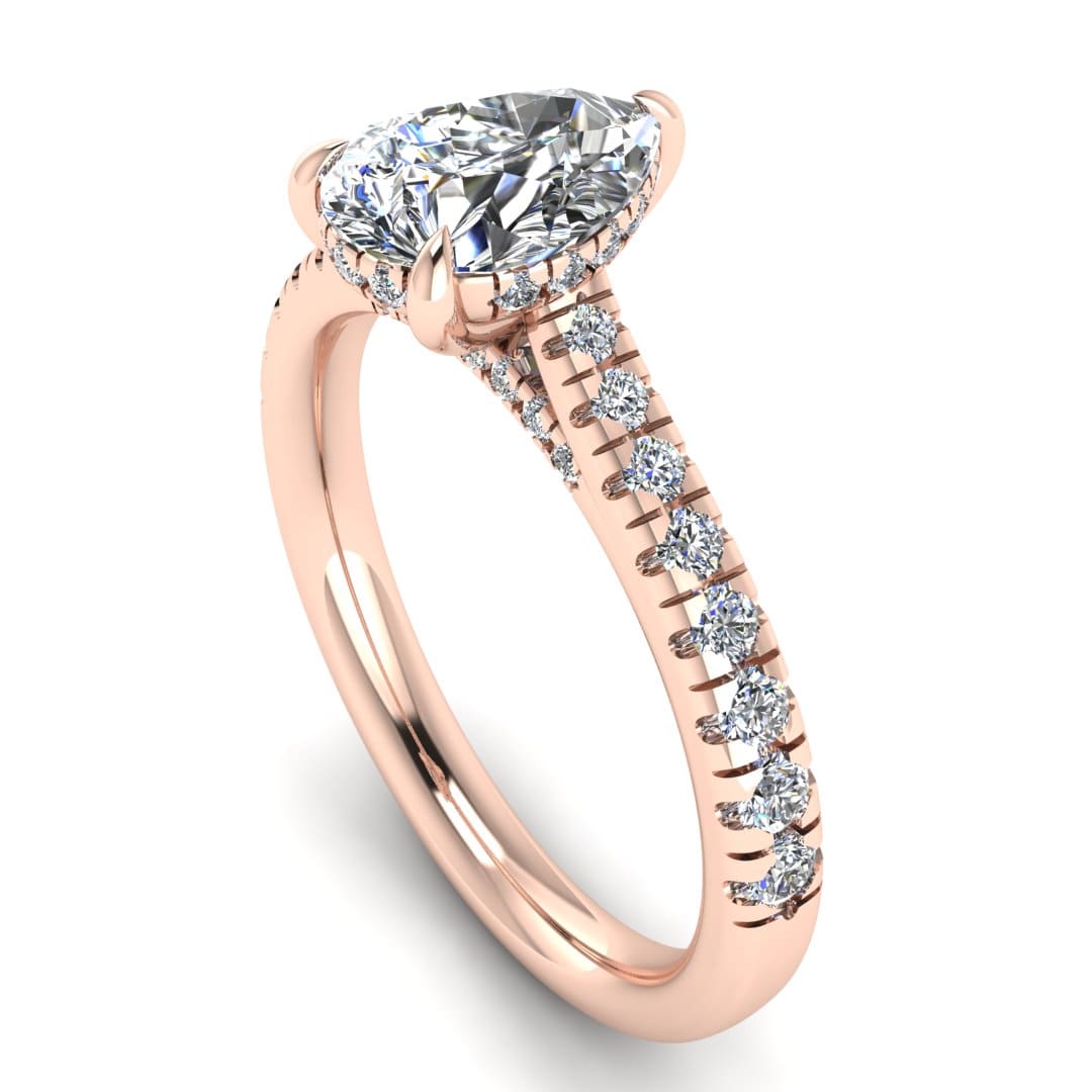 angled view of a rose gold engagement ring, there is a pear cut centre lab grown diamond which has a hidden under halo and pavé-set diamond shoulders