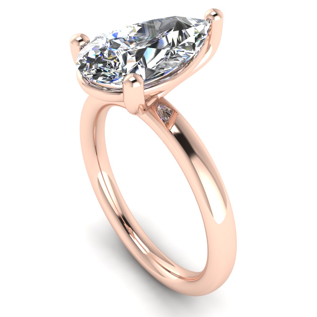 angled view of a rose gold engagement ring with a pear cut lab grown ethical and sustainable diamond