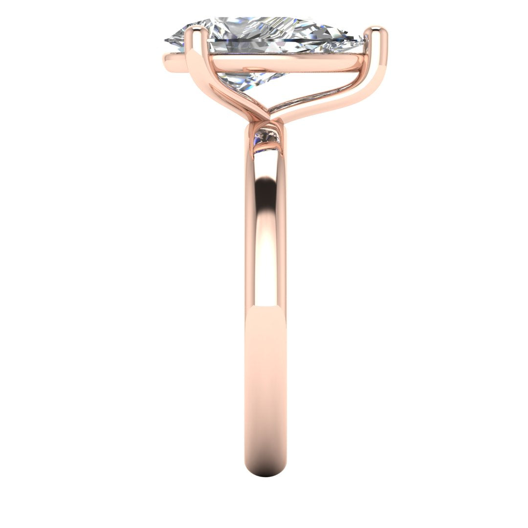 side view of a rose gold engagement ring with a pear cut lab grown ethical and sustainable diamond