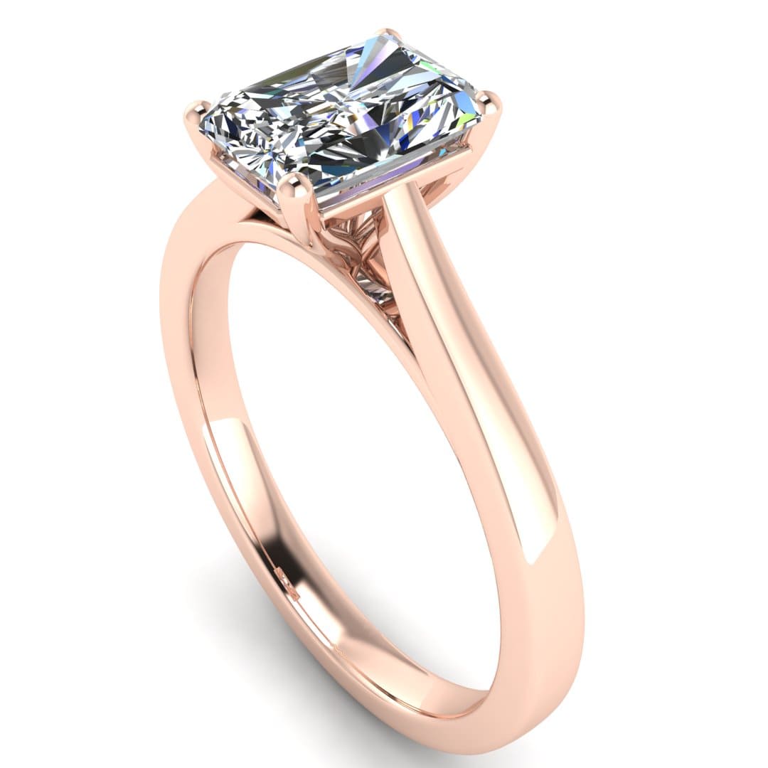 angled view of a rose gold engagement ring set with a radiant cut lab grown diamond with 4 claws