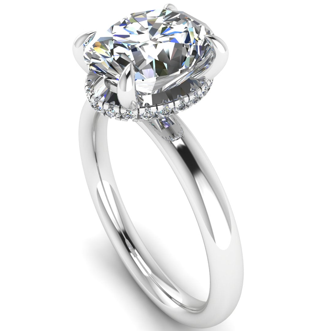 Angled profile of a white gold and platinum engagement ring with a oval cut lab grown diamond with a secret hidden halo