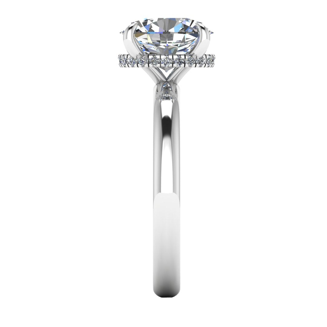 Side profile of a white gold and platinum engagement ring with a oval cut lab grown diamond with a secret hidden halo