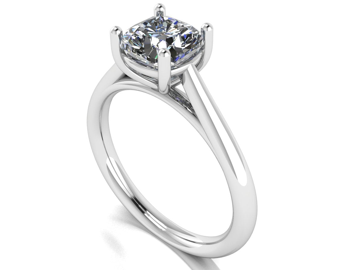 angled view of a platinum or white gold single solitaire engagement ring featuring a cushion cut lab grown diamond in a cathedral setting with 4 claws