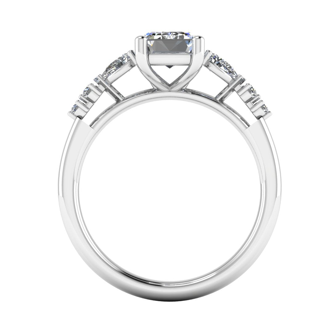 flat view of a platinum and white gold engagement ring. There is an emerald cut centre lab grown diamond with an arrangement of pear shaped and round diamonds on each side
