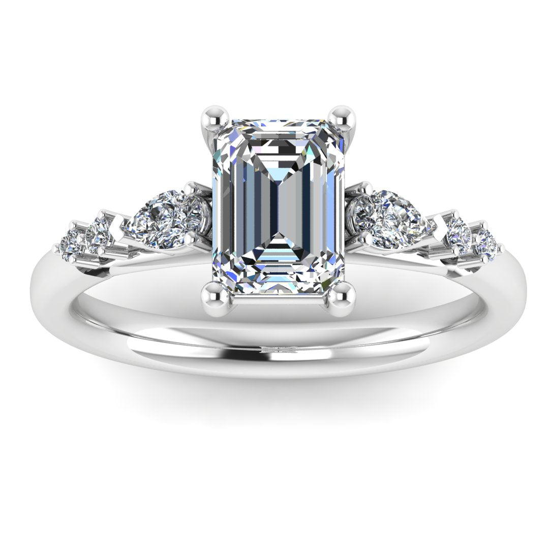 front view of a platinum and white gold engagement ring. There is an emerald cut centre lab grown diamond with an arrangement of pear shaped and round diamonds on each side