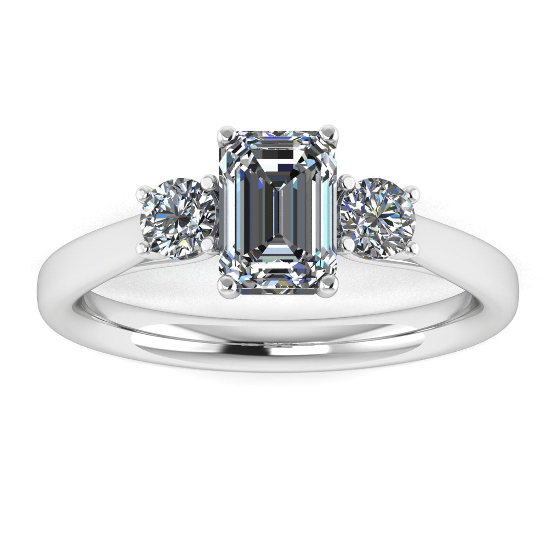 front view of a trilogy platinum or white gold engagement ring set with an emerald centre lab grown diamond with two round brilliant diamonds on either side of the centre stone