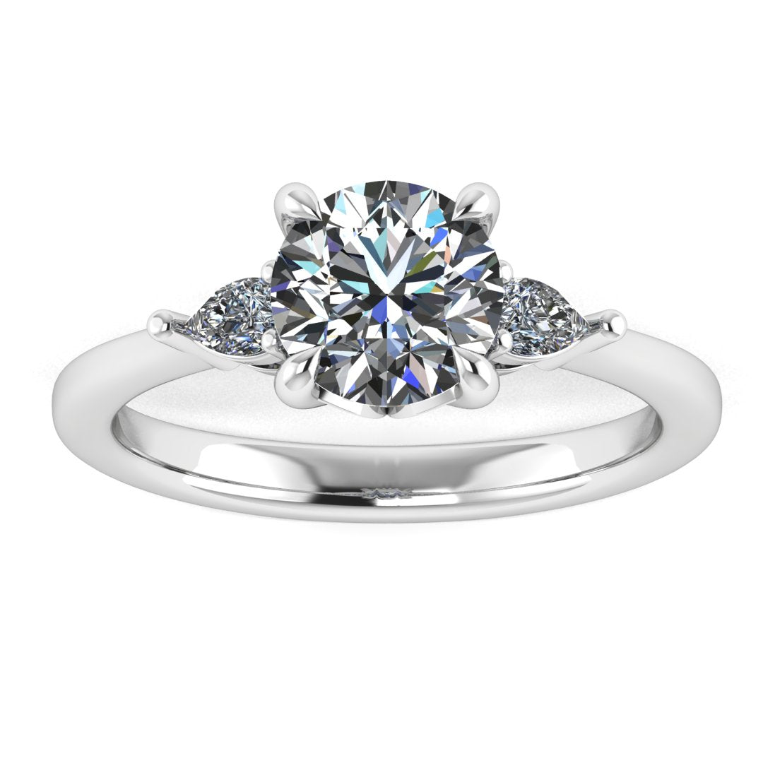Front view of a white gold and platinum trilogy engagement ring using round and pear shaped lab grown diamonds