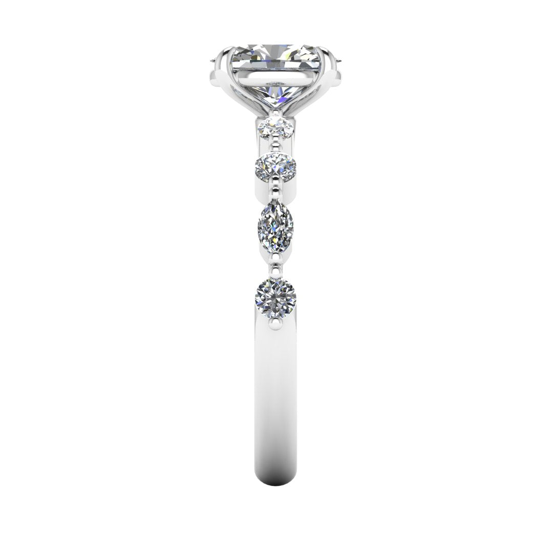 side view of platinum or white gold of Lily engagement ring with an oval cut centre stone surrounded by alternating smaller round and marquise stones on the shoulder