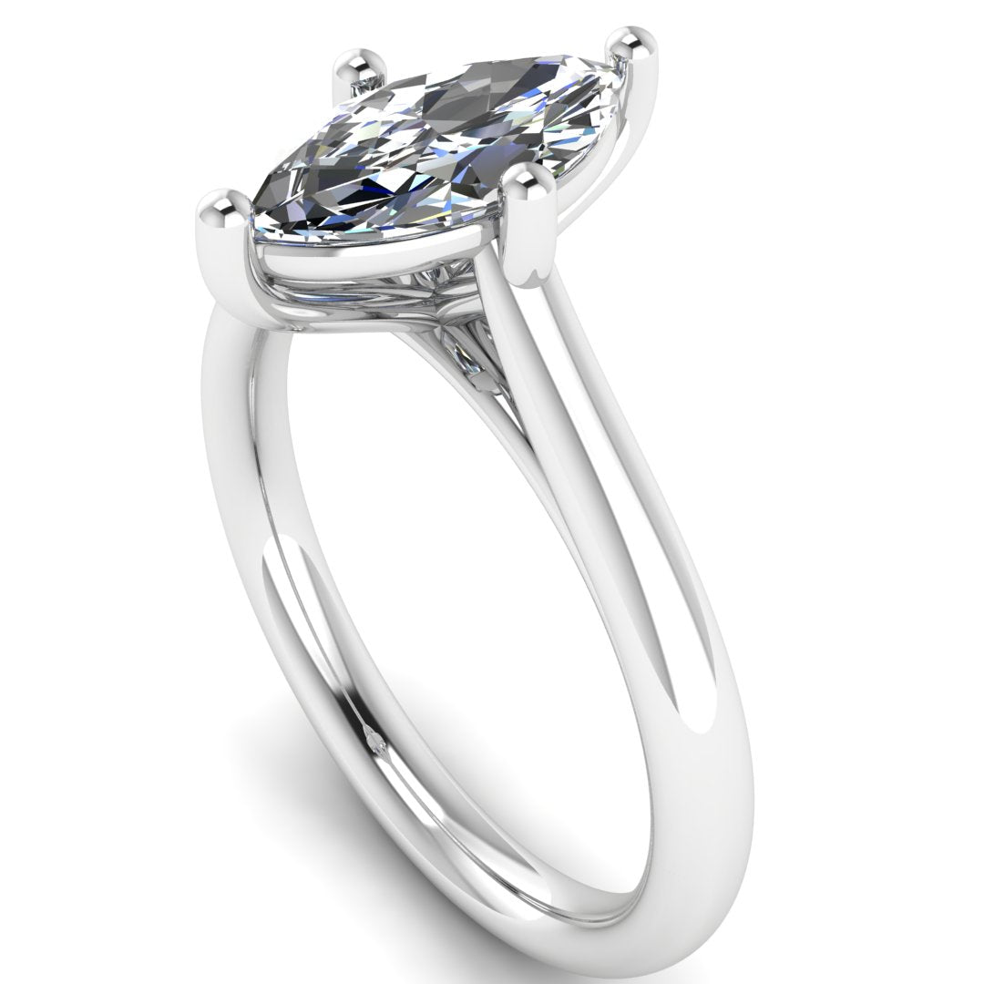 angled view of platinum or white gold single solitaire engagement ring with a marquise cut lab grown ethical and sustainable diamond in a cathedral setting