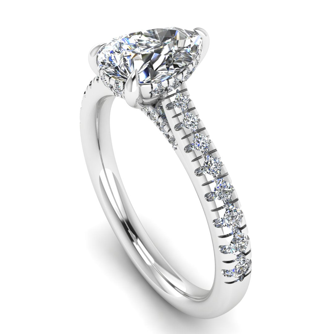 angled view of a platinum or white gold engagement ring, there is a pear cut centre lab grown diamond which has a hidden under halo and pavé-set diamond shoulders