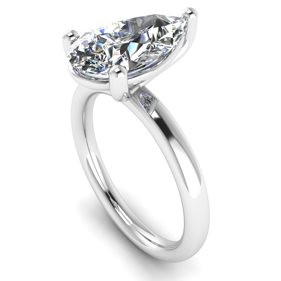 angled view of a platinum or white gold engagement ring with a pear cut lab grown ethical and sustainable diamond