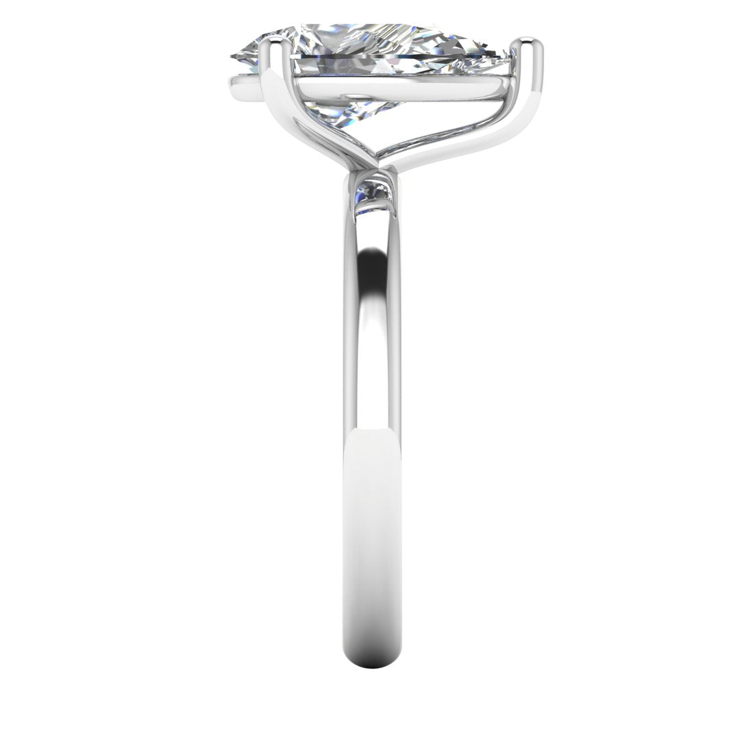 side view of a platinum or white gold engagement ring with a pear cut lab grown ethical and sustainable diamond