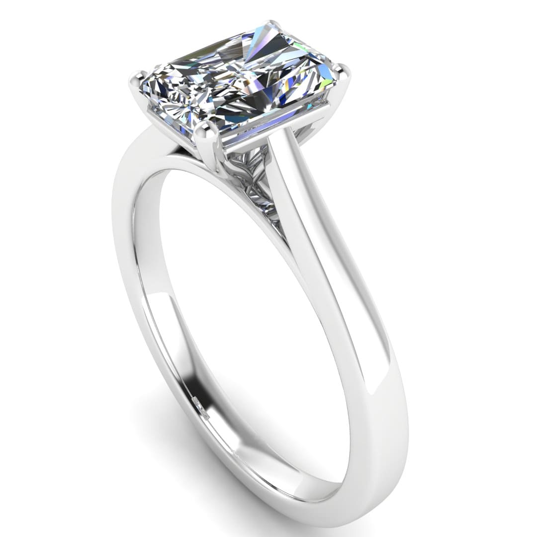 angled view of a platinum or white gold engagement ring set with a radiant cut lab grown diamond with 4 claws
