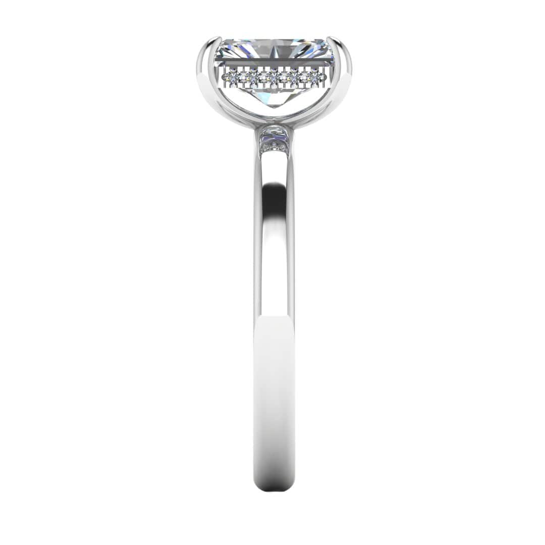 side view of a platinum or white gold single solitaire engagement with set with a radiant cut lab grown diamond featuring a secret hidden under halo