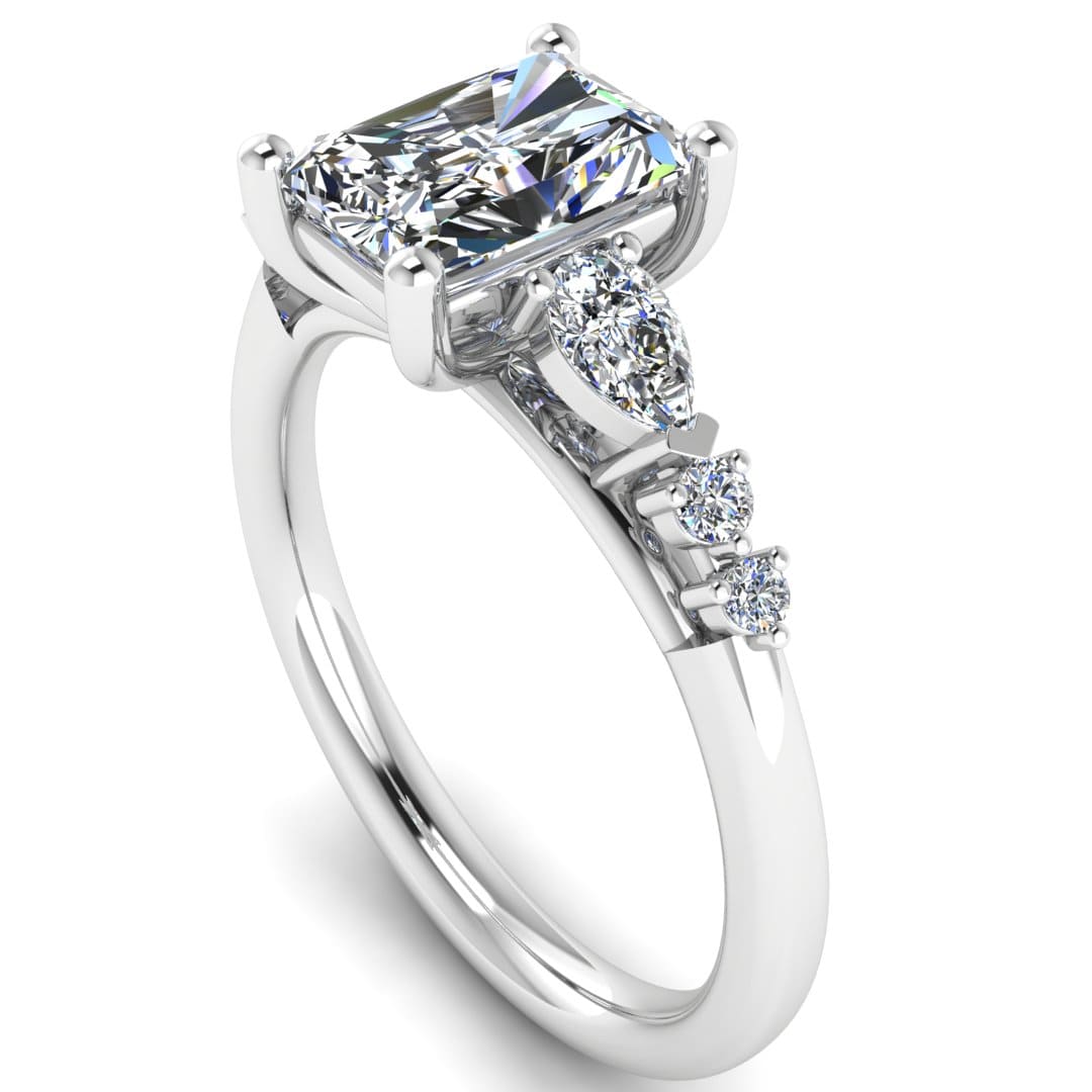 angled view of a platinum or white gold multi-stone lab grown diamond engagement ring. It features a radiant cut lab-grown diamond with one pear and two round side diamonds on either side