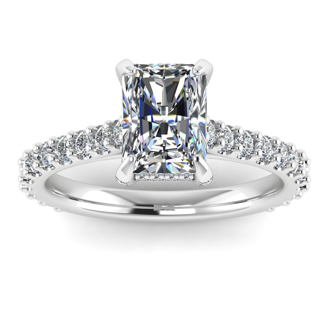 front view of Ellie platinum or white gold engagement ring which has a central emerald cut lab grown diamond, elegant under-halo, pavé-set shoulders, and delicate diamonds on the prongs for extra sparkle