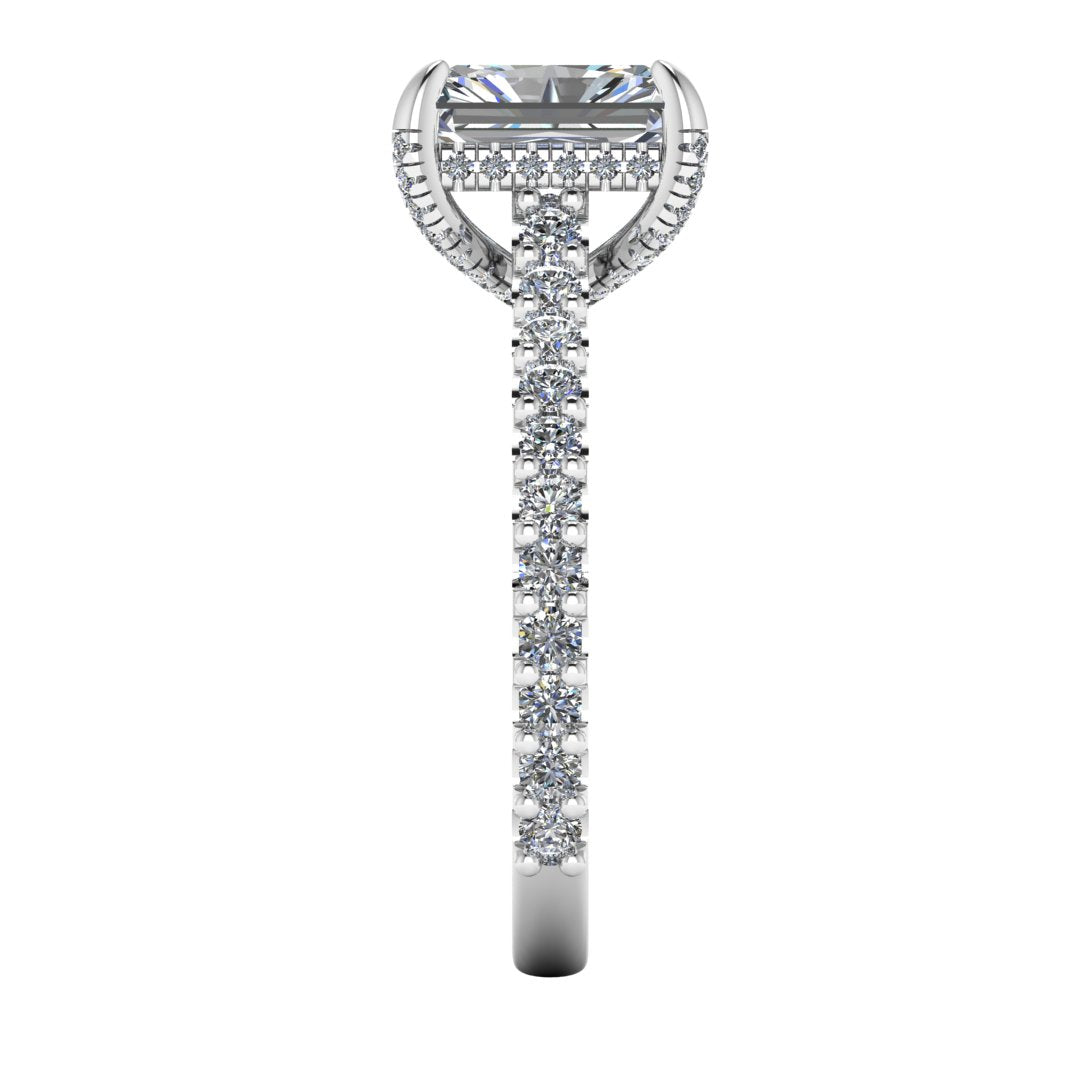 side view of Ellie platinum or white gold engagement ring which has a central emerald cut lab grown diamond, elegant under-halo, pavé-set shoulders, and delicate diamonds on the prongs for extra sparkle