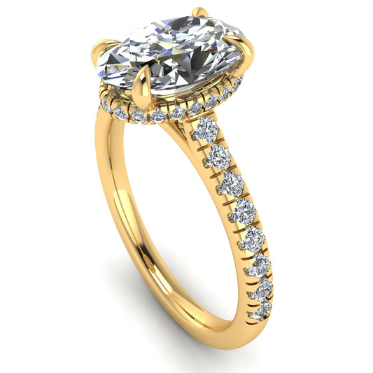 Angled view of yellow gold oval cut lab grown diamond engagement ring with secret hidden halo and diamond band