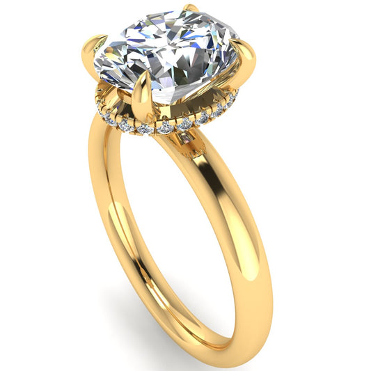 Angled profile of a yellow gold engagement ring with a oval cut lab grown diamond with a secret hidden halo