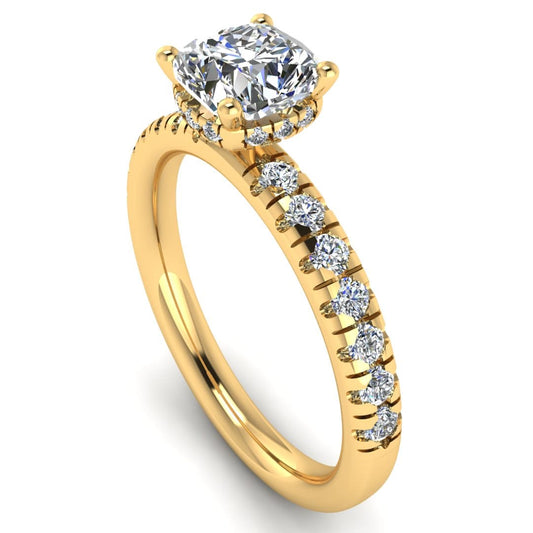 angled view of a yellow gold cushion cut lab grown diamond engagement ring with pavé shoulders and a hidden halo
