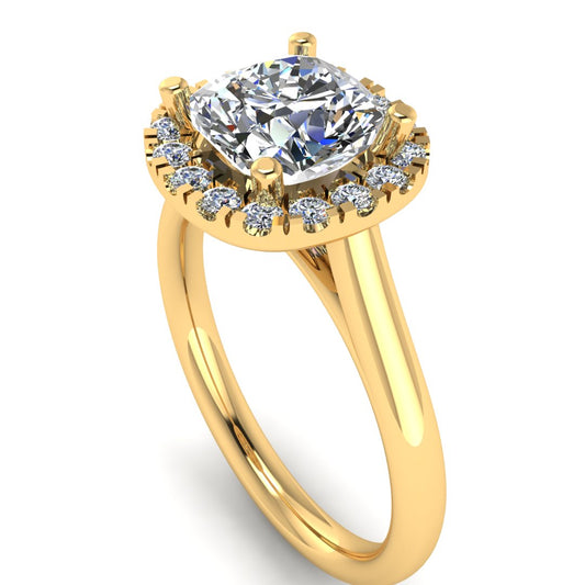 angled view of a yellow gold cushion cut lab grown diamond engagement ring framed by a sparkling halo
