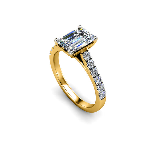 angled view of a yellow gold engagement ring with an emerald cut lab-grown diamond as the centre stone with pavé-set diamond shoulders