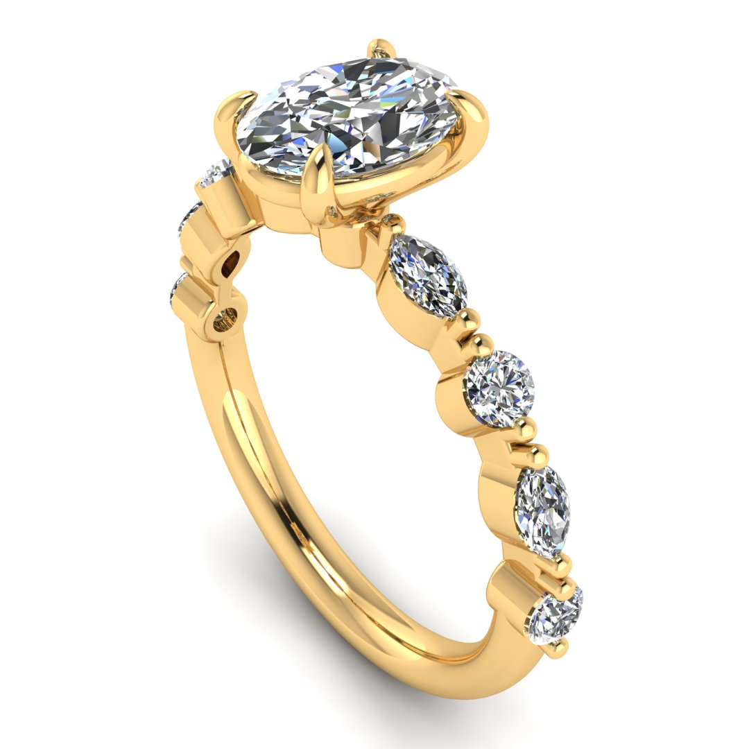 angled view of yellow gold of Lily engagement ring with an oval cut centre stone surrounded by alternating smaller round and marquise stones on the shoulder