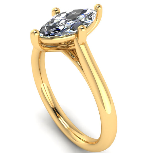 angled view of yellow gold single solitaire engagement ring with a marquise cut lab grown ethical and sustainable diamond in a cathedral setting