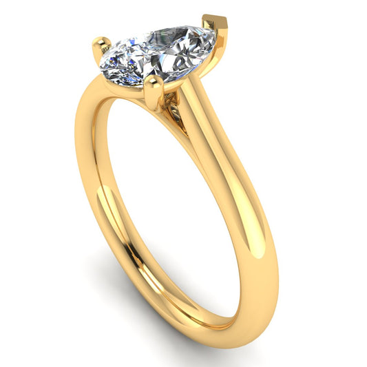 angled view of yellow gold engagement ring with a pear cut lab grown diamond which is ethical and sustainable