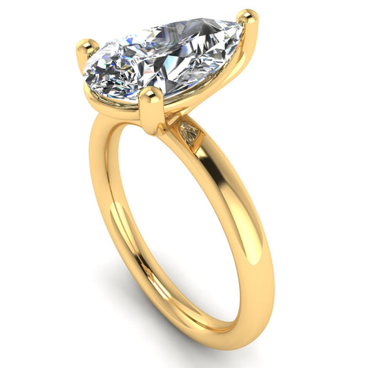 angled view of a yellow gold engagement ring with a pear cut lab grown ethical and sustainable diamond