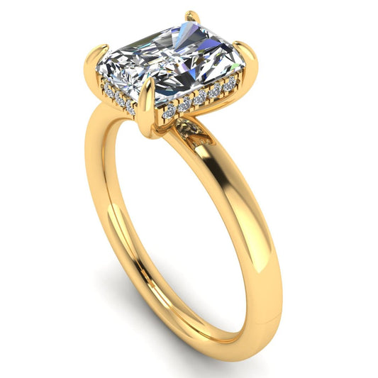 angled view of a yellow gold single solitaire engagement with set with a radiant cut lab grown diamond featuring a secret hidden under halo