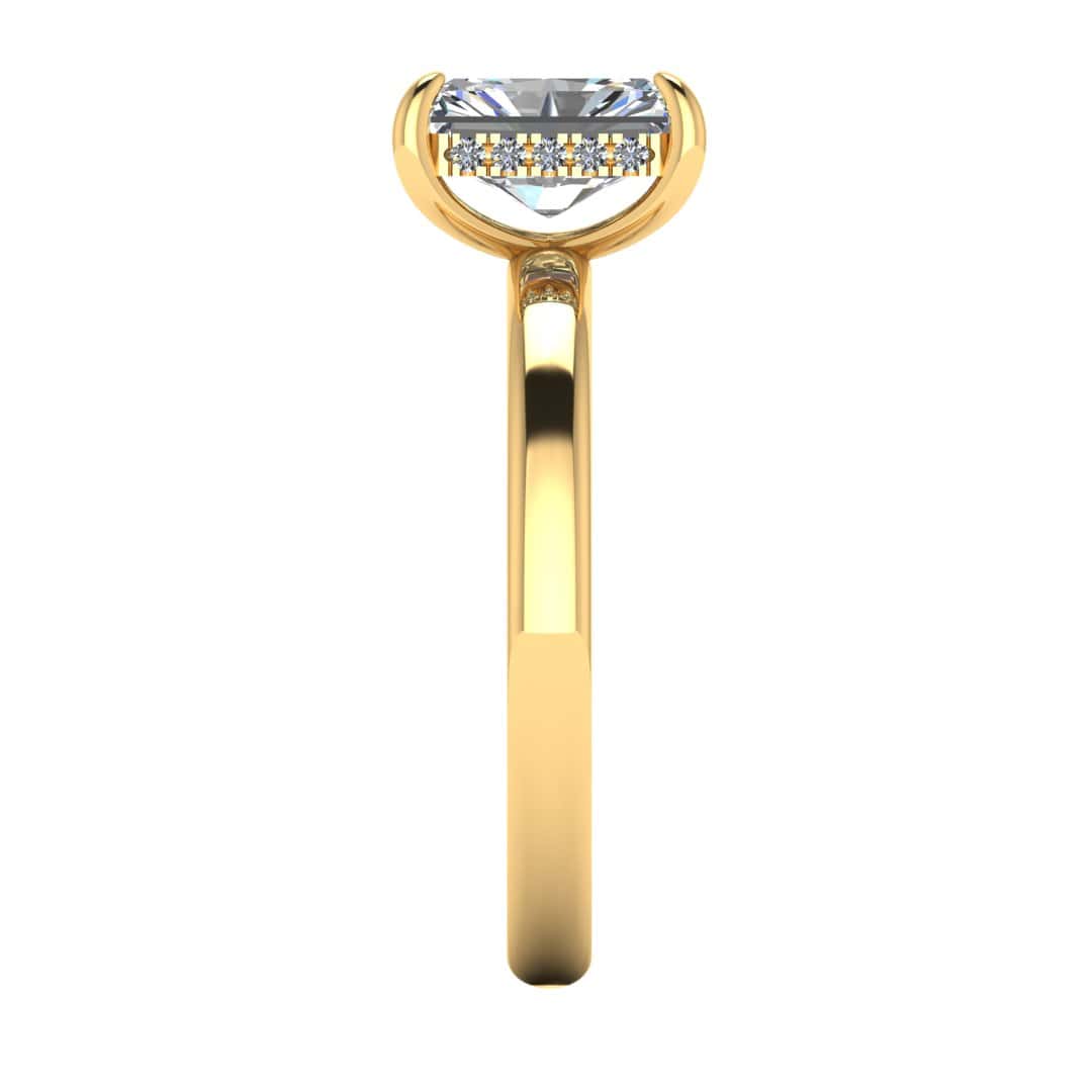 side view of a yellow gold single solitaire engagement with set with a radiant cut lab grown diamond featuring a secret hidden under halo