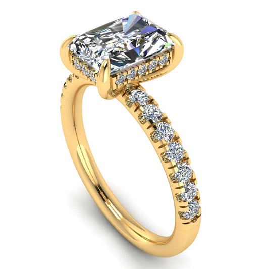 angled view of yellow gold engagement ring featuring a radiant cut lab-grown diamond with pavé-set shoulders and a hidden halo