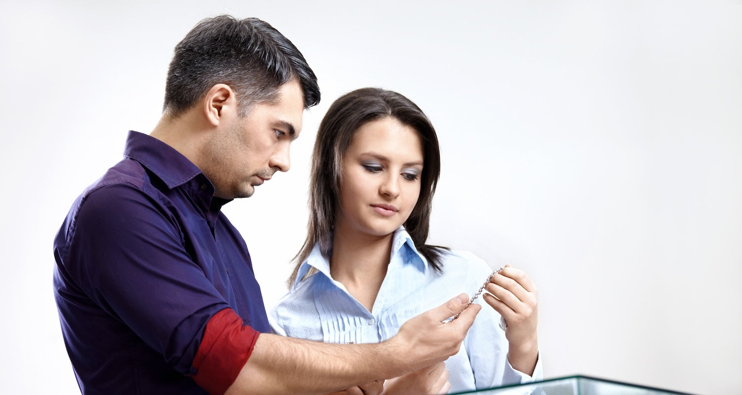 Couple admiring a lab-grown diamond tennis bracelet, exploring ethical luxury jewellery option