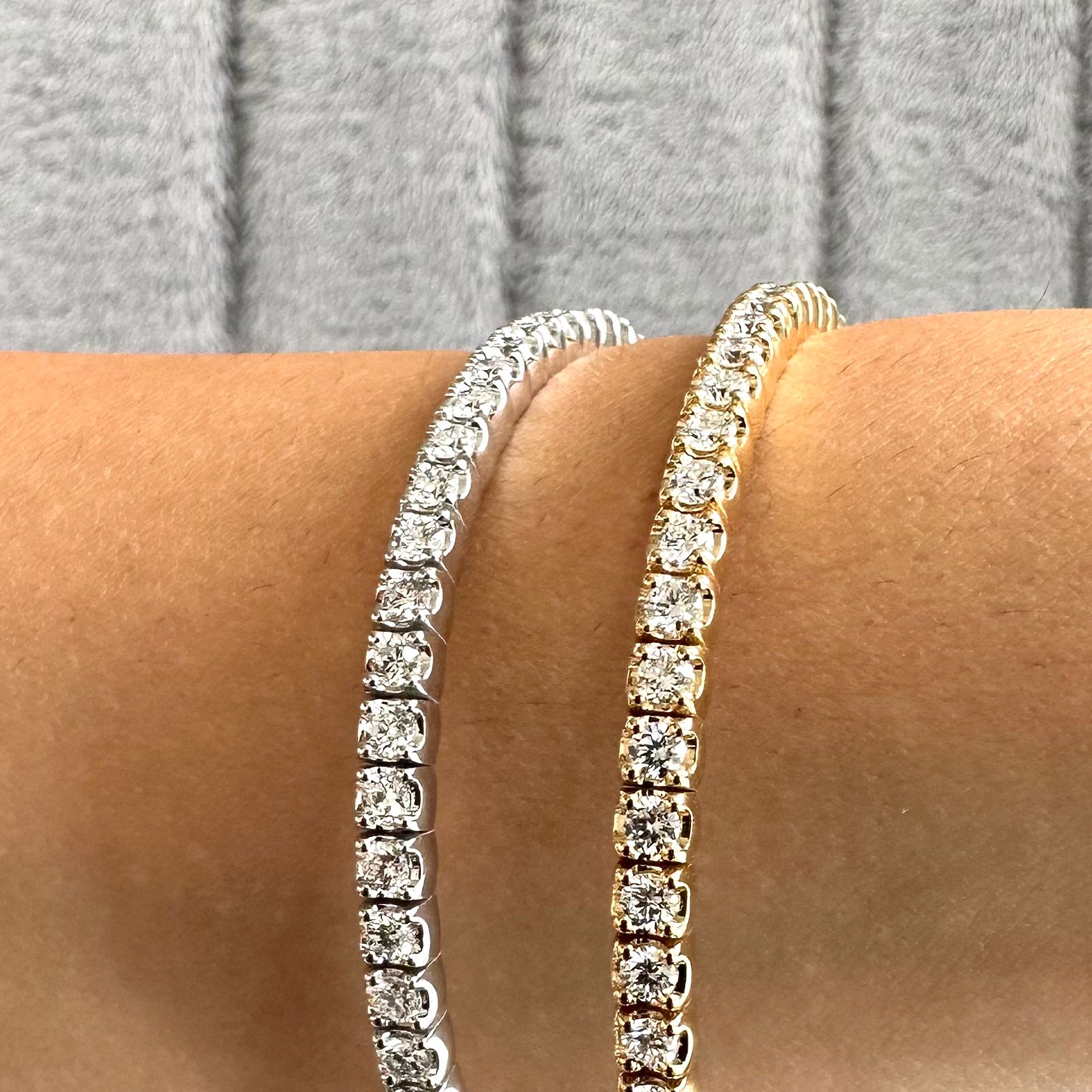close up lifestyle shot showing a platinum or white gold and yellow gold flexible bangle on the wrist of a model