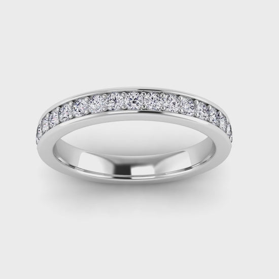 video view of a platinum or white gold eternity ring or wedding band with round brilliant lab-grown diamonds set in a fine grain setting