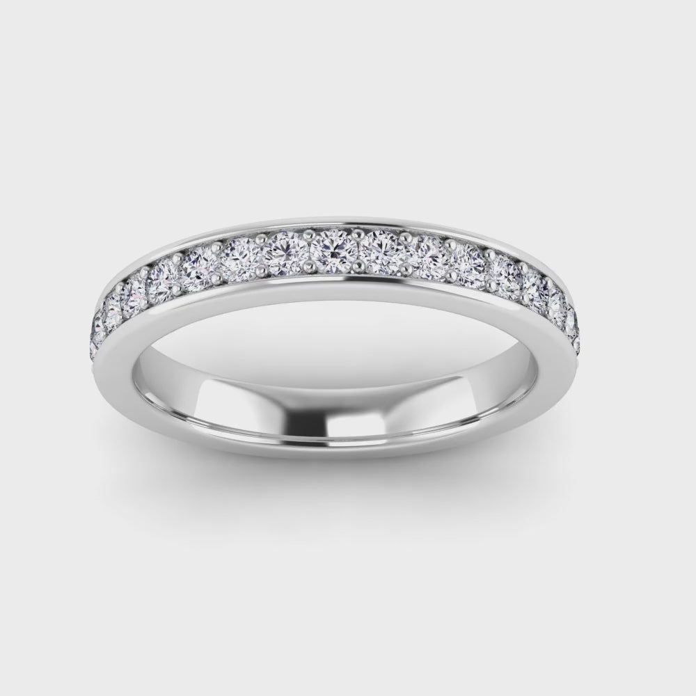 video view of a platinum or white gold eternity ring or wedding band with round brilliant lab-grown diamonds set in a fine grain setting