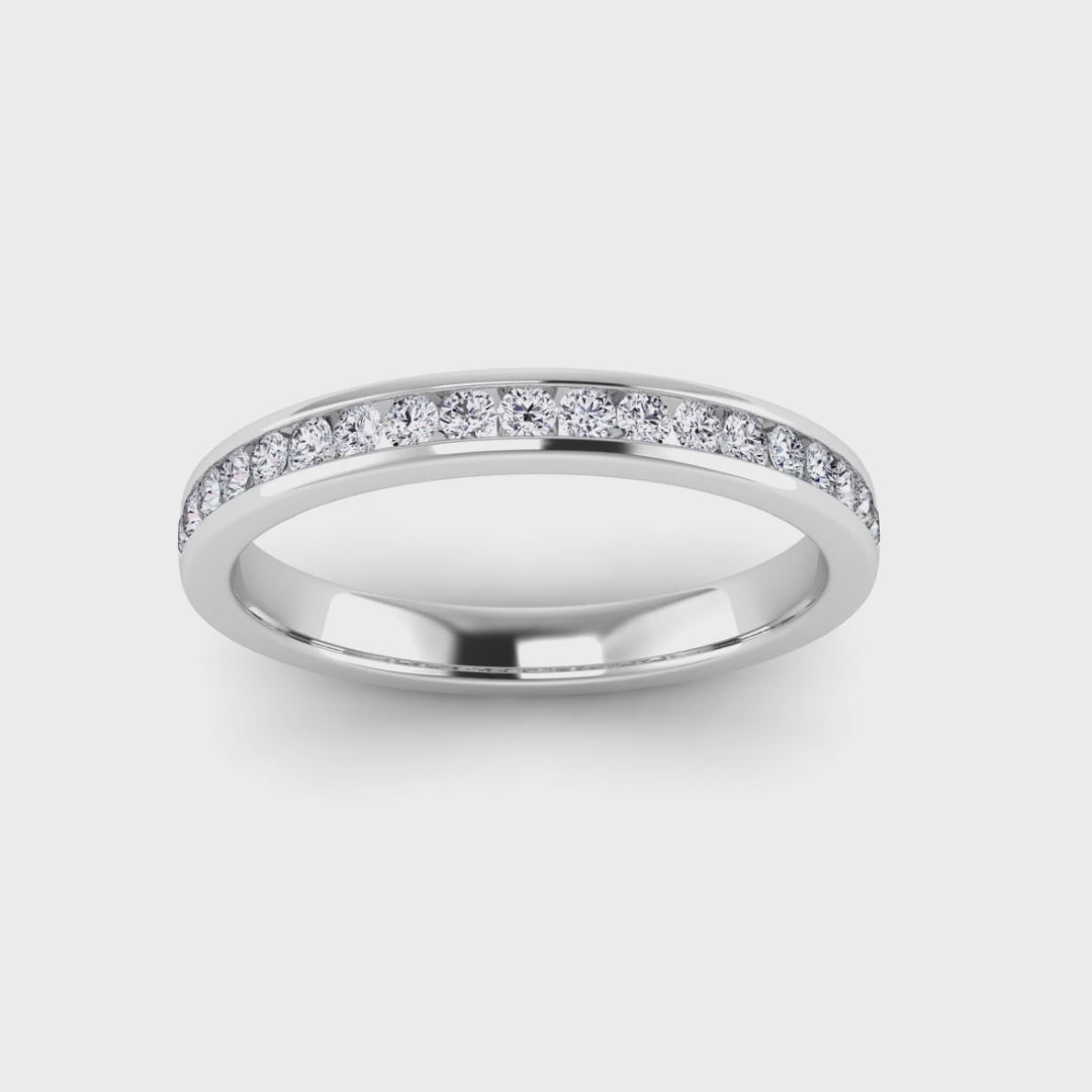 video view of a platinum or white gold eternity ring or wedding band with round brilliant lab grown diamonds in a channel setting