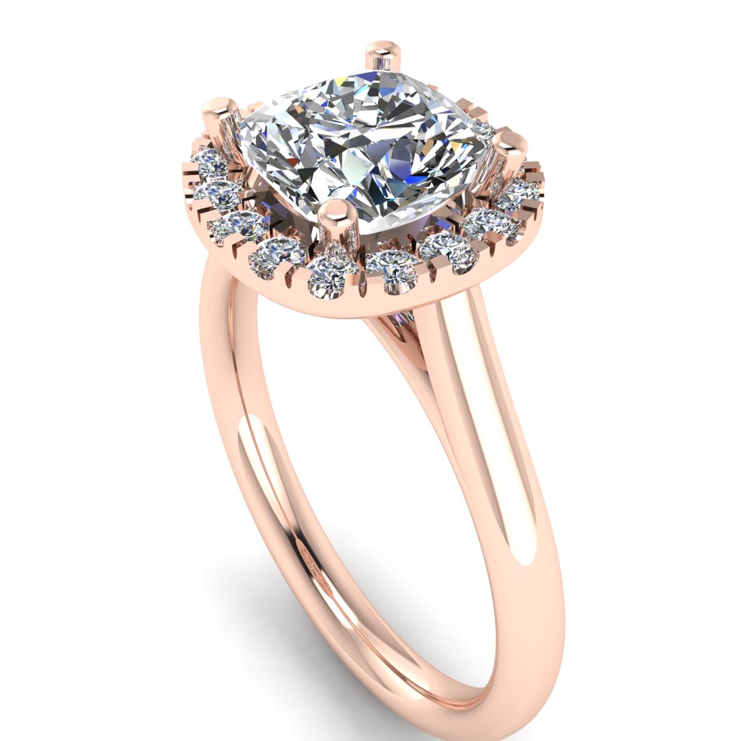 angled view of a rose gold cushion cut lab grown diamond engagement ring framed by a sparkling halo