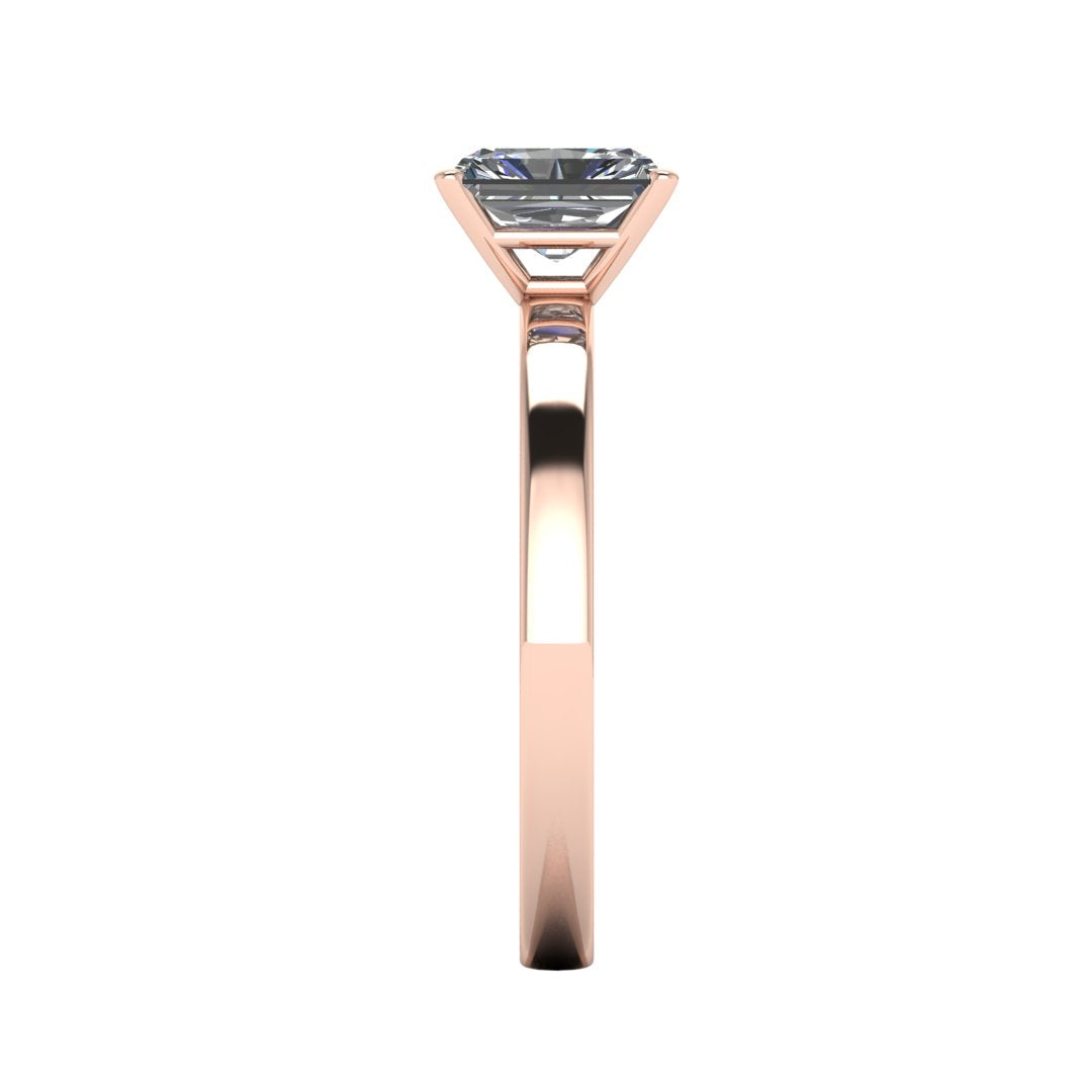 side view of rose gold engagement ring with an emerald cut lab grown diamond as the centre stone in a floating setting