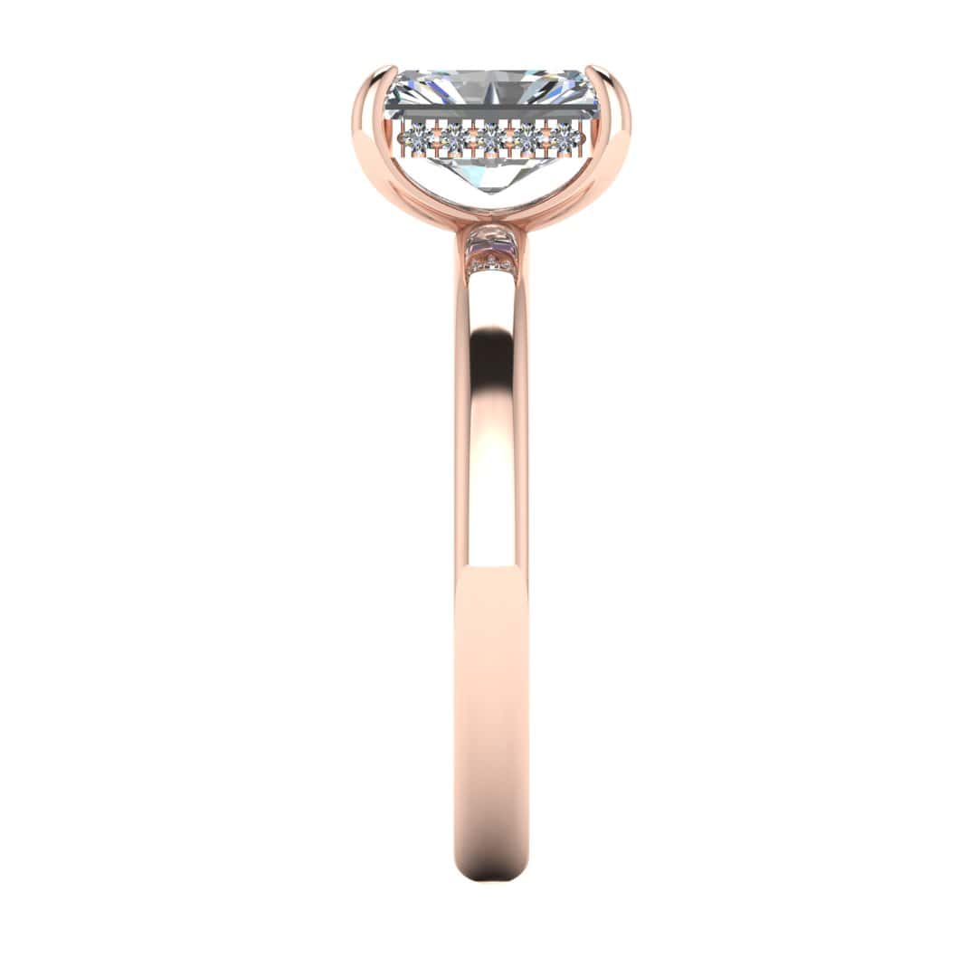 side view of a rose gold single solitaire engagement with set with a radiant cut lab grown diamond featuring a secret hidden under halo