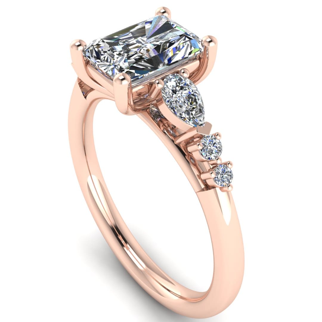angled view of a rose gold multi-stone lab grown diamond engagement ring. It features a radiant cut lab-grown diamond with one pear and two round side diamonds on either side